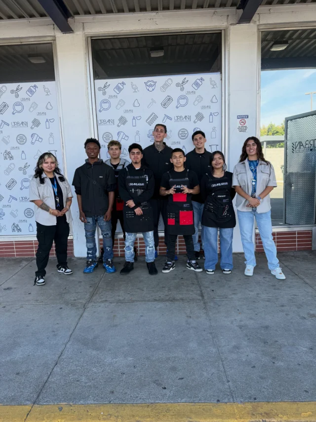 Urban Barber College class celebrating moving onto the clinic floor