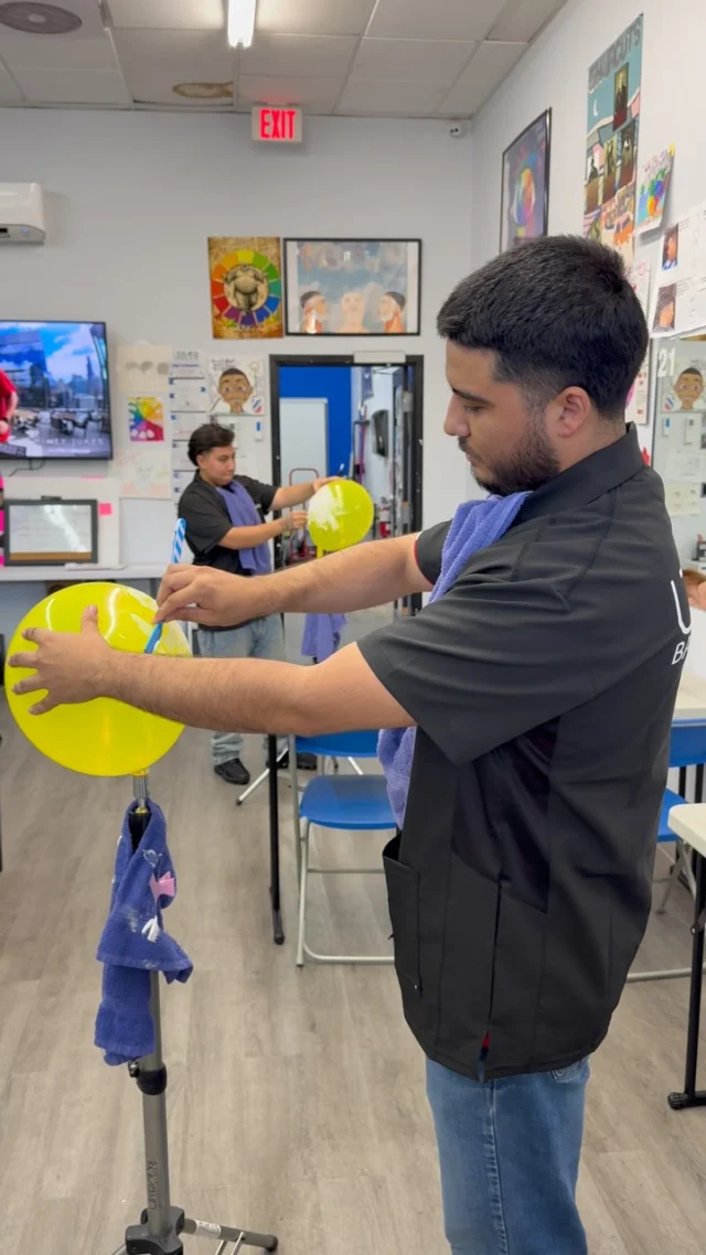 Barber student practicing shaving skills at Urban Barber College