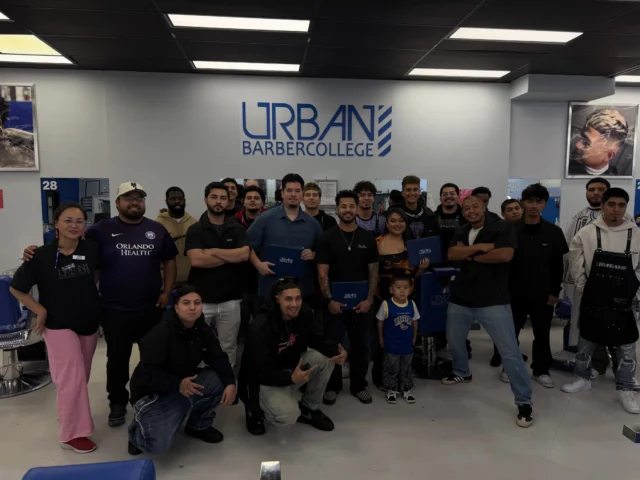 Group of Urban Barber College graduates celebrating after finishing 1,000 hours